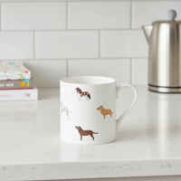 White mug with dog illustrations and the word 'Fetch' on a white background
