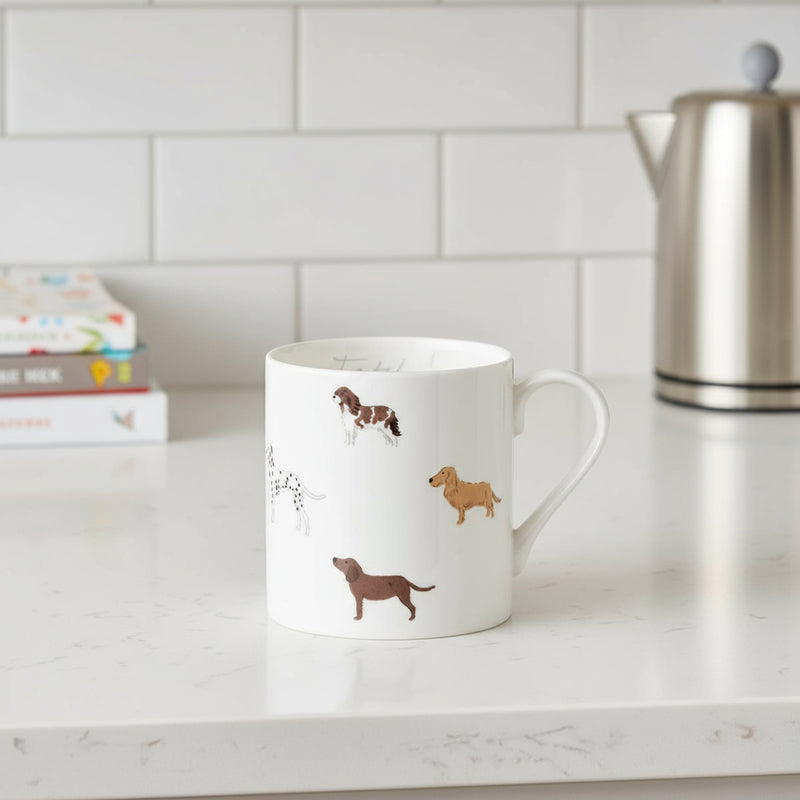White mug with dog illustrations and the word 'Fetch' on a white background