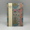 Floral notebook with a visible brand on a gray background