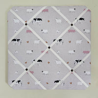 Memo board with farm animal pattern on a light gray background