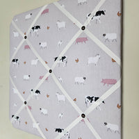 Memo board with farm animal pattern on a light gray background