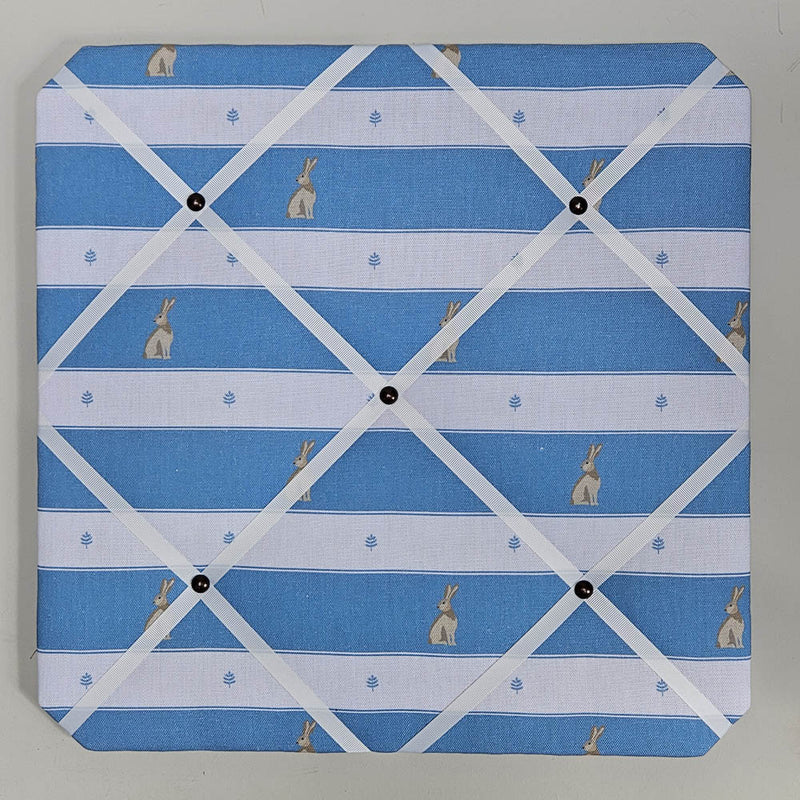 Memo board with blue and white striped pattern and small rabbit illustrations.
