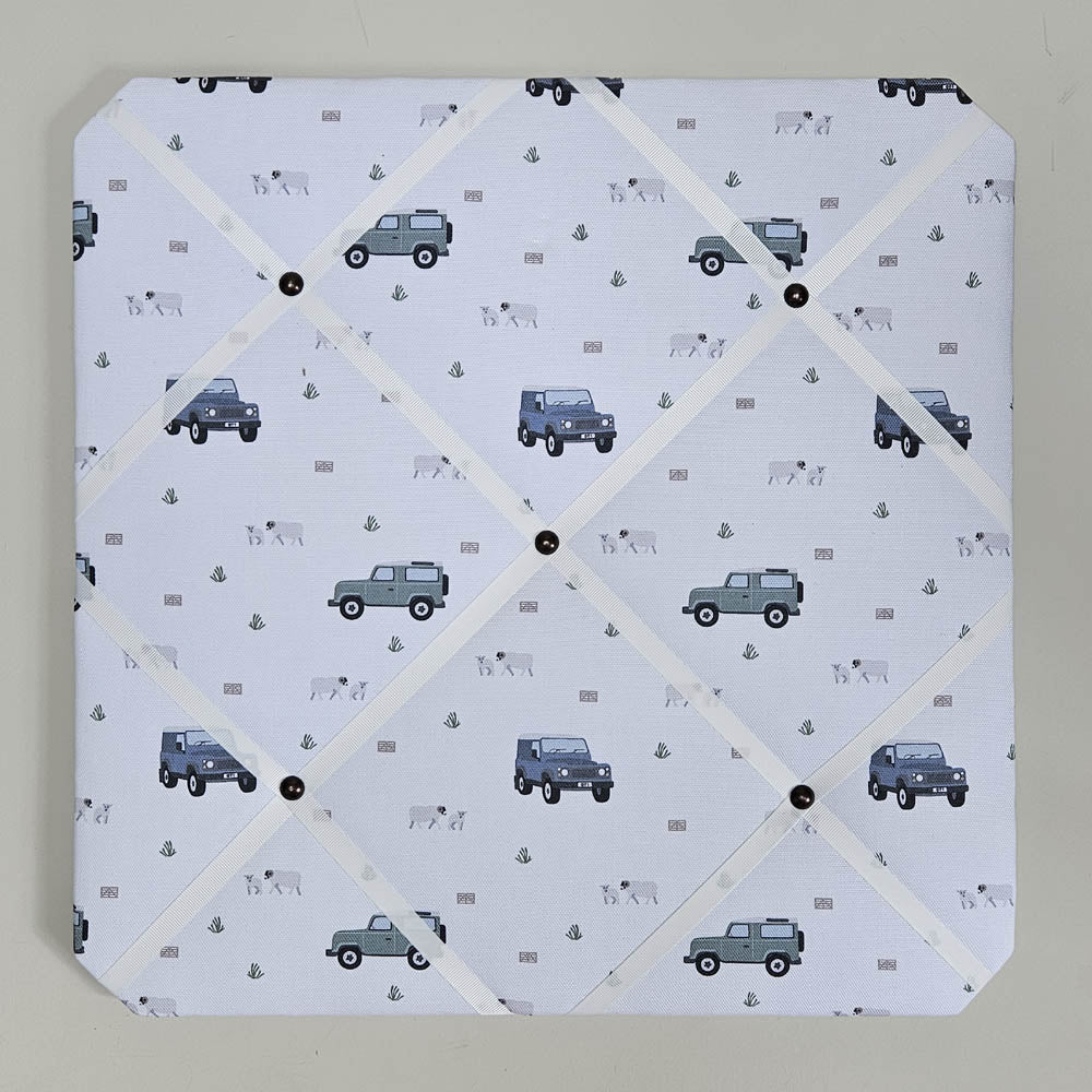Memo board with vehicle pattern on a light gray background
