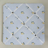 Memo board with lemon pattern on a blue and white striped background