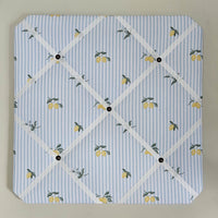 Memo board with lemon pattern on a blue and white striped background