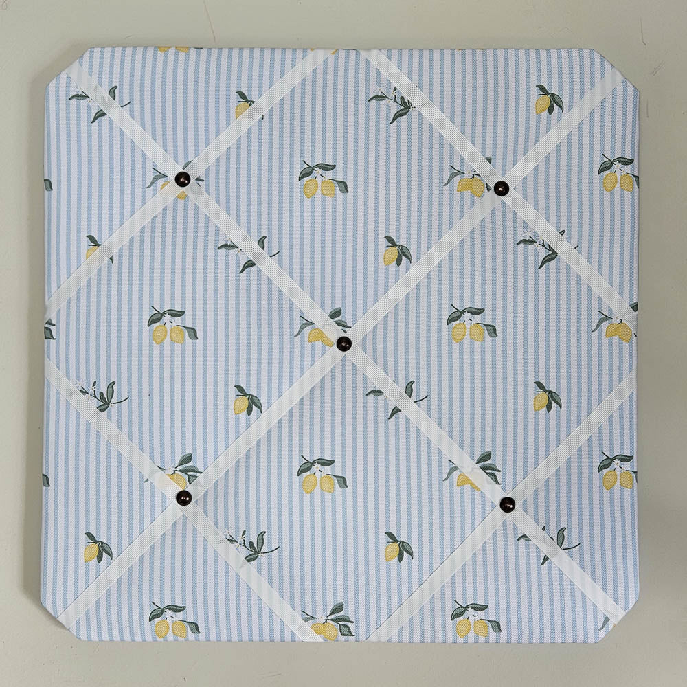 Memo board with lemon pattern on a blue and white striped background