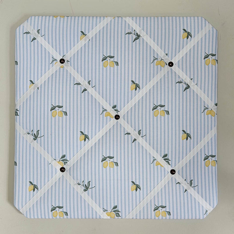 Memo board with lemon pattern on a blue and white striped background
