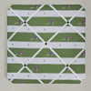 Memo board with a green and white pattern of people playing golf on a plain background