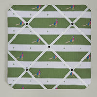Memo board with a green and white pattern of people playing golf on a plain background
