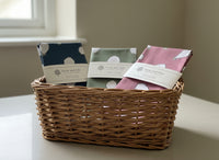 Three folded tea towels with animal pattern on a wooden surface