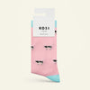 Pink sock with black cow pattern and blue cuff and sole, displayed on a white background with KOSI London packaging.