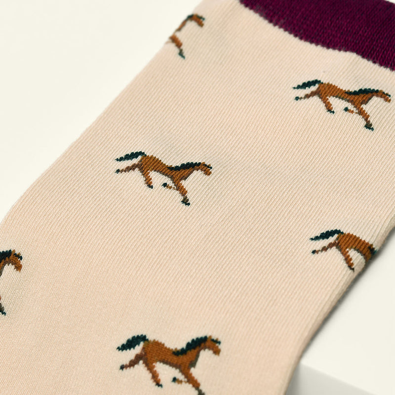 Beige sock with horse pattern on a white background