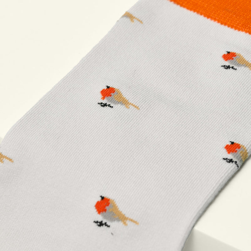White sock with red and yellow bird designs on a white background