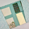 Set of stationery items including notebooks and an envelope with floral patterns and 'Morris & Co' branding.