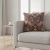 Decorative pillow with floral and bird pattern on a red background